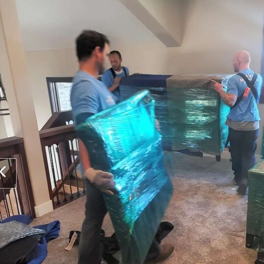 A Moving company in Casper Wyoming, Dams, providing moving helpers, is seen moving furniture in a house.