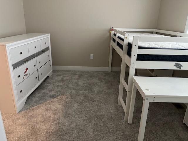 A small bedroom with a bunk bed and dresser, suitable for local or long distance moves by Dams Moving Company in Casper Wyoming.