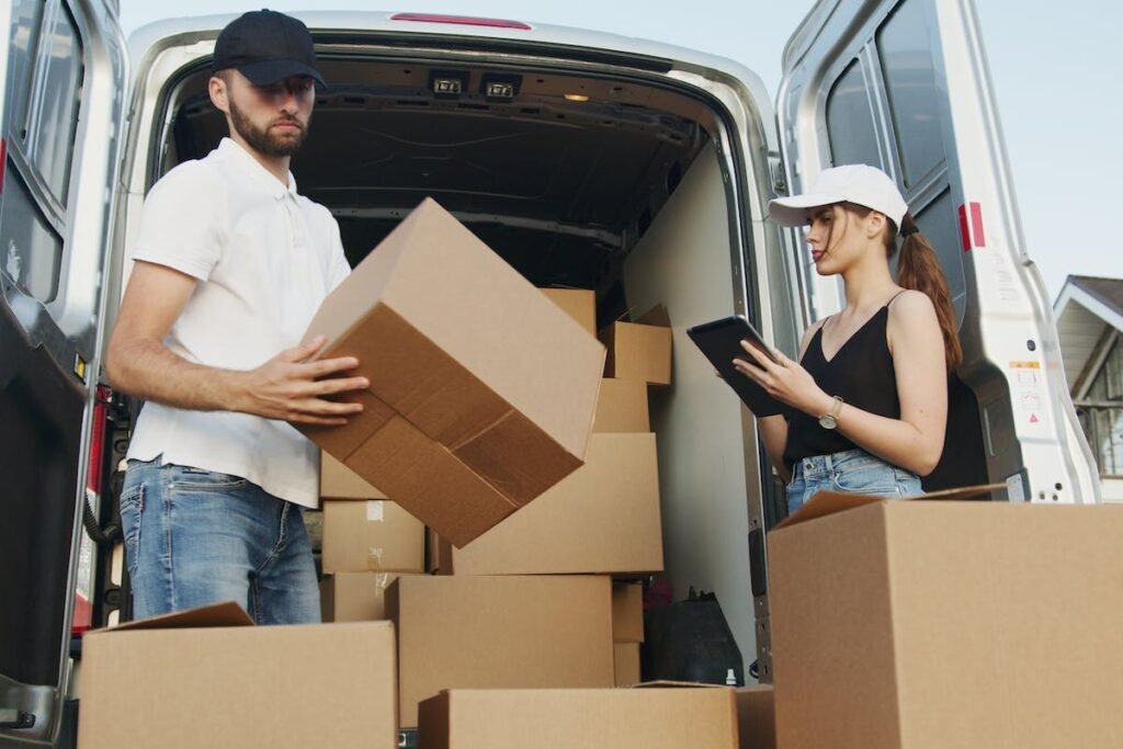 From Start to Finish: A Comprehensive Guide to Hiring Professional Movers - A man and woman loading boxes into a moving van.